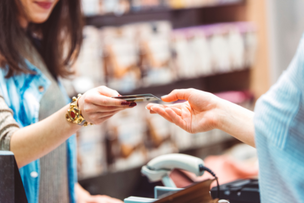 Customer handing cashier a card